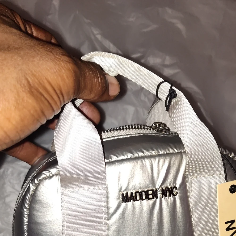 Steve Madden Silver Backpack. Front and side pockets.